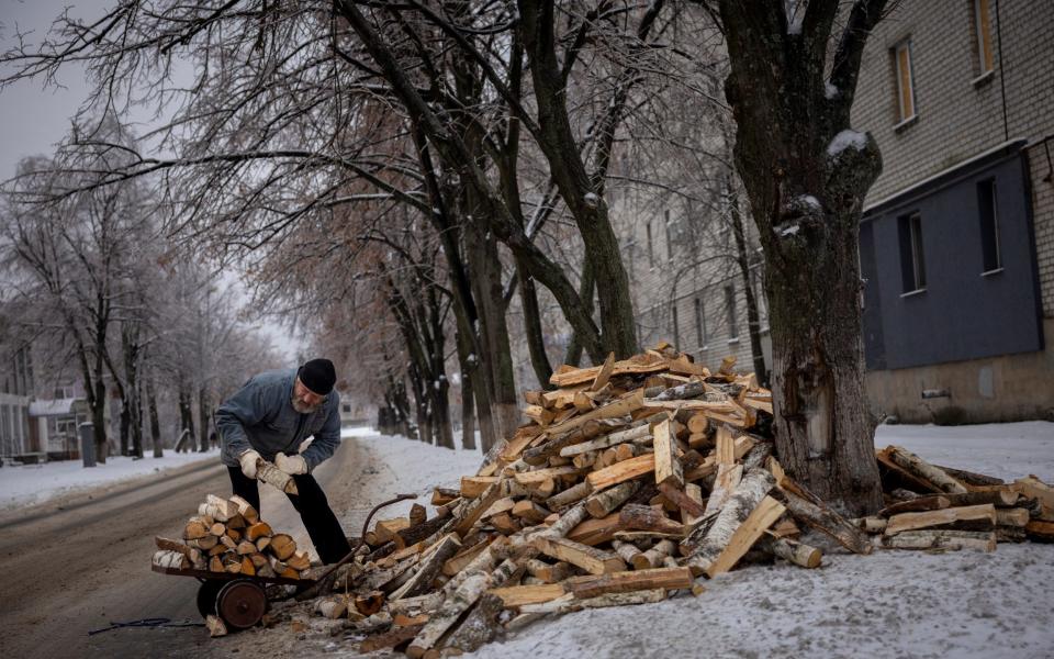 Hennadiy Batsak, 63, collects wood to heat his apartment that lacks heating, water and gas in the frontline town of Lyman,