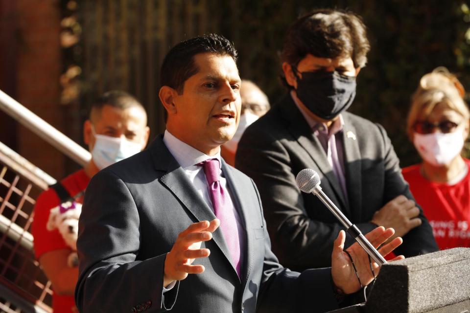 A man speaks at a lectern.