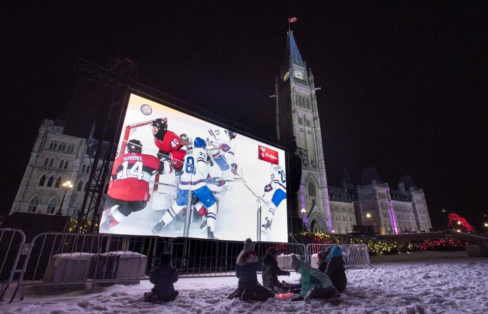 <p>A giant video screen on Parliament Hill’s west lawn streams the NHL 100 Classic at nearby Landsdowne Park in Ottawa on Saturday. </p>