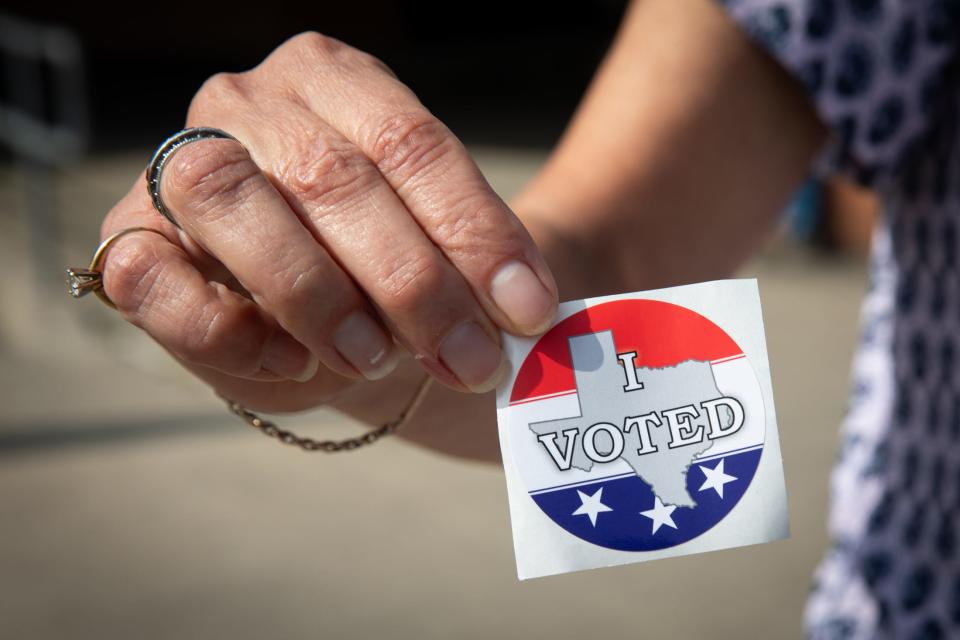 Mary Alice Ramos holds up a sticker she received after voting at former Carroll High School campus polling location on Primary Election Day, Tuesday, March 5, 2024, in Corpus Christi, Texas.