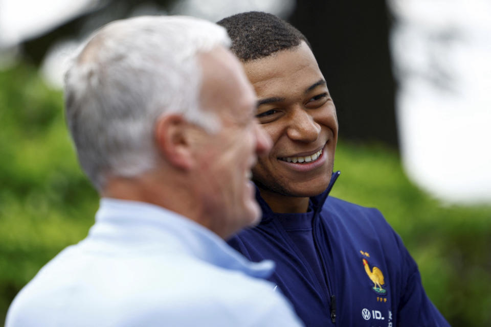 French soccer player Kylian Mbappe, right, talks to head coach Didier Deschamps at the national soccer team training center in Clairefontaine, west of Paris, Monday, June 3, 2024 ahead of the UEFA Euro 2024. (Sarah Meyssonnier/Pool photo via AP)