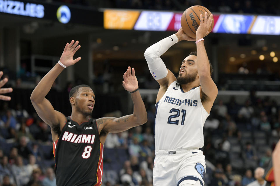 Memphis Grizzlies guard Tyus Jones (21) shoots against Miami Heat forward Jamal Cain (8) in the second half of a preseason NBA basketball game Friday, Oct. 7, 2022, in Memphis, Tenn. (AP Photo/Brandon Dill)