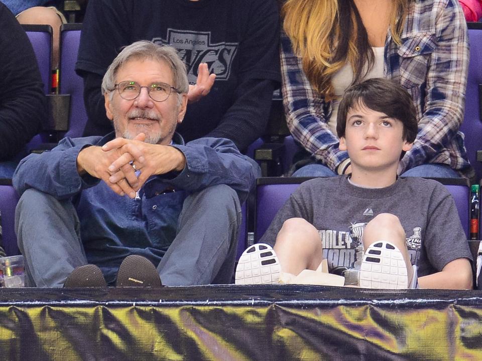 Harrison Ford (L) and Liam Flockhart attend a hockey game between the Carolina Hurricanes and the Los Angeles Kings at Staples Center on March 1, 2014 in Los Angeles, California