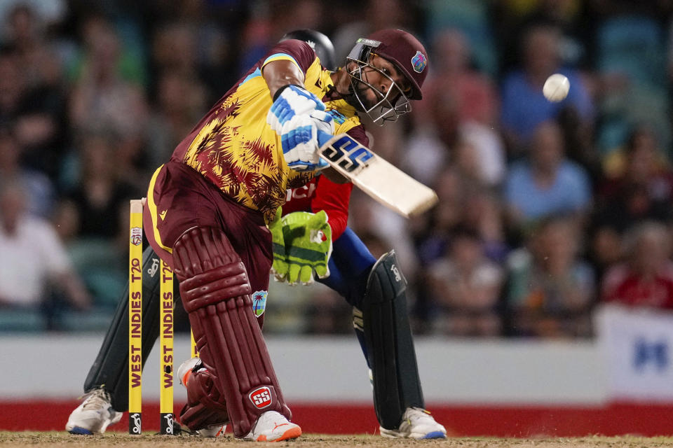 West Indies' Nicholas Pooran hits a six from a delivery of England's Adil Rashid during the first T20 cricket match at Kensington Oval in Bridgetown, Barbados, Tuesday, Dec. 12, 2023. (AP Photo/Ricardo Mazalan)