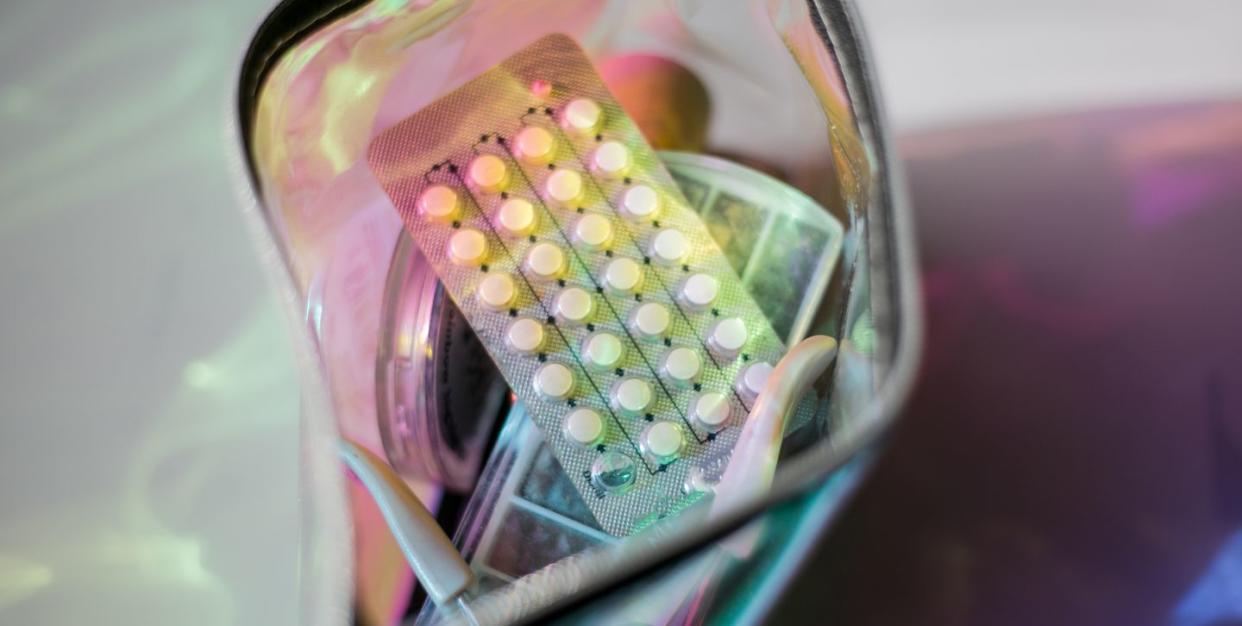 birth control pills in a metallic holographic bag