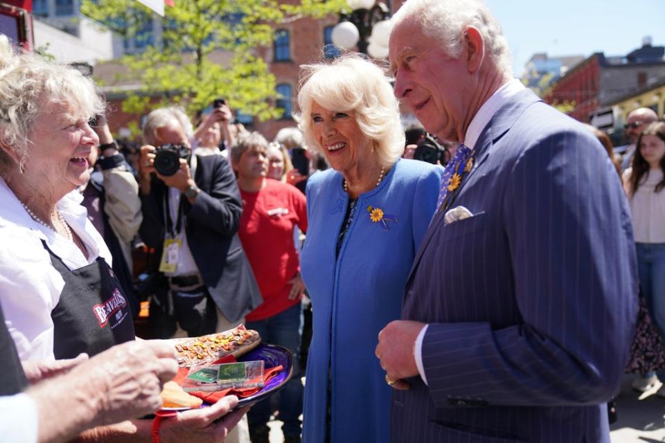 The Prince of Wales and Duchess of Cornwall are shown local produce at ByWard Market in Ottawa(Jacob King/PA) (PA Wire)