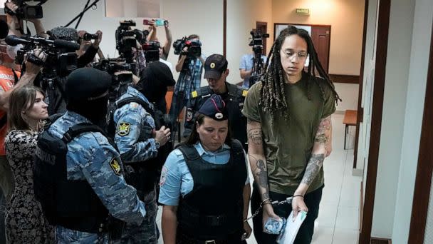 PHOTO: WNBA star and two-time Olympic gold medalist Brittney Griner is escorted in a court room prior to a hearing, in Khimki, just outside Moscow, Russia, on Aug. 2, 2022. (Alexander Zemlianichenko/AP)