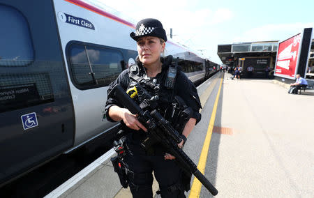 An armed police officer patrols on a platform at Milton Keynes station, Britain May 25, 2017. REUTERS/Neil Hall