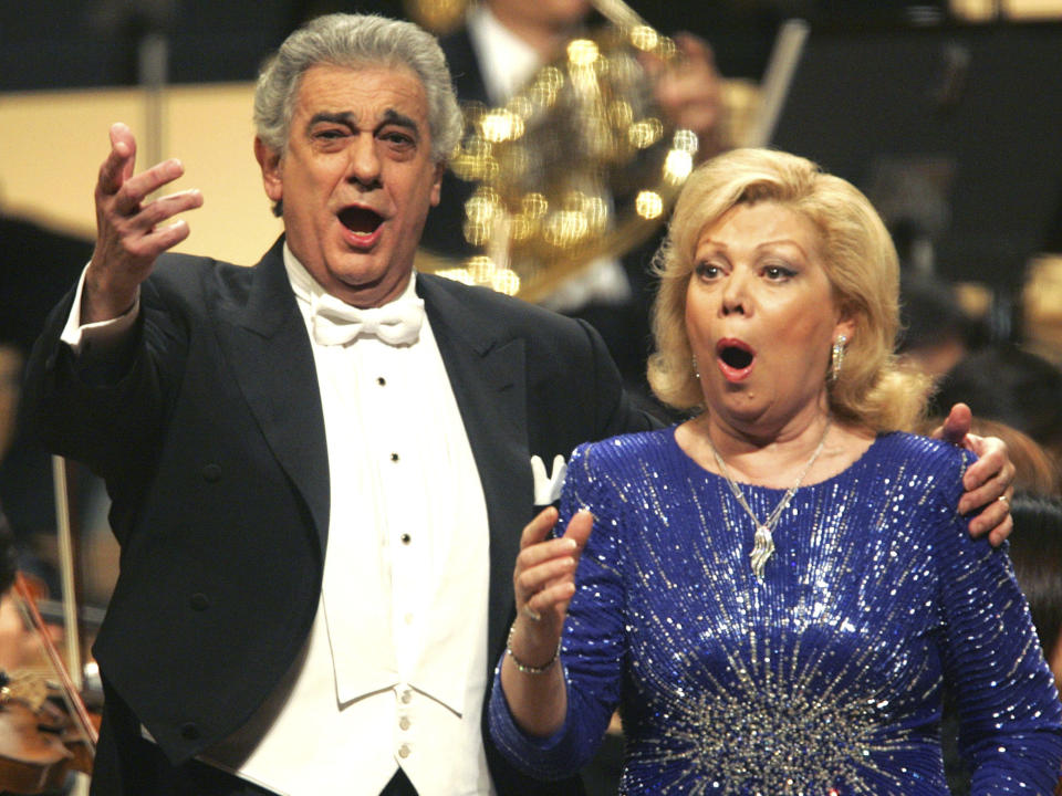 FILE - In this Wednesday, Dec. 8, 2004 file photo, Placido Domingo, left, and Mirella Freni sing Giuseppe Verdi's Otello Act I love duet "Gia nella notte densa" together during their joint concert in Tokyo Mirella. Freni, an Italian soprano whose uncommon elegance and intensity combined with a sumptuous voice and intelligence to enthrall opera audiences for a half-century, has died at age 84. Freni's manager said she died Sunday Feb. 9, 2020 at her home in Modena, Italy. (AP Photo/Shizuo Kambayashi, File)