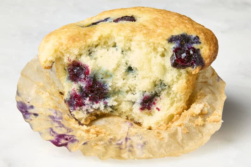 head on shot of the Ina Garten blueberry muffin with a bite taken out of it.