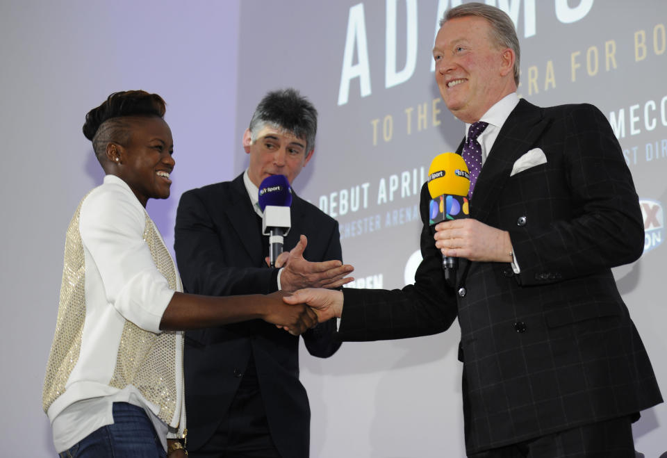 Nicola Adams, left, shakes hands with boxing promoter, Frank Warren, during a press announcement in central London, Monday Jan. 23, 2017. Two-time Olympic women's boxing champion Nicola Adams has turned professional. The 34-year-old flyweight from Britain has joined promoter Frank Warren and will make her professional debut in Manchester on April 8. (Charlotte Ball/PA via AP)