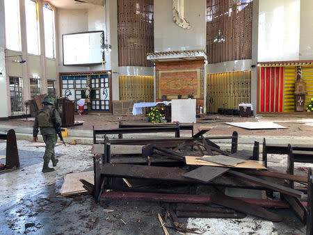 A Philippine Army member walks inside a church after a bombing attack in Jolo, Sulu province, Philippines January 27, 2019. Armed Forces of the Philippines - Western Mindanao Command/Handout via REUTERS