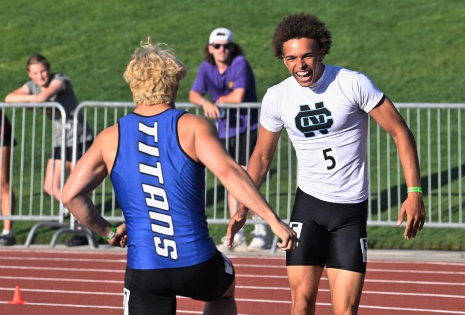 Clovis North’s Nickolas Miller, right, celebrates his first place finish in the boys 100 with Frontier’s Brycen Tablit, left, at the 2023 CIF Central Section Masters track and field meet, held at Veterans Memorial Stadium on Saturday, May 20, 2023 in Clovis.