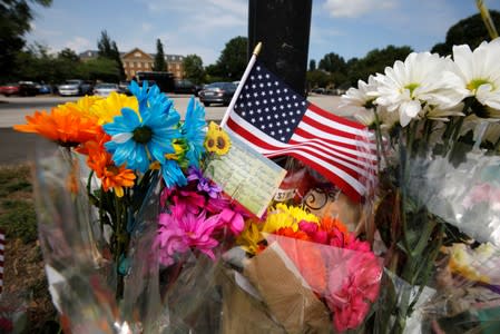 A card lists the names of the victims at a makeshift memorial outside a municipal government building where a shooting incident occurred in Virginia Beach, Virginia