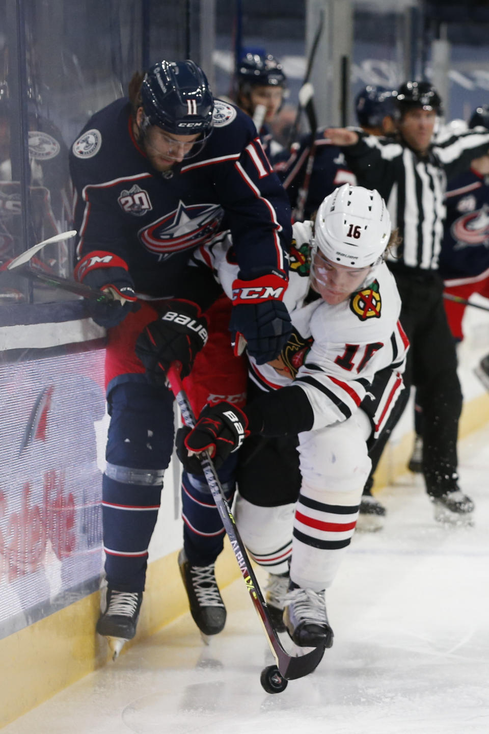 Chicago Blackhawks' Nikita Zadorov, right, checks Columbus Blue Jackets' Kevin Stenlund during the second period of an NHL hockey game Thursday, Feb. 25, 2021, in Columbus, Ohio. (AP Photo/Jay LaPrete)