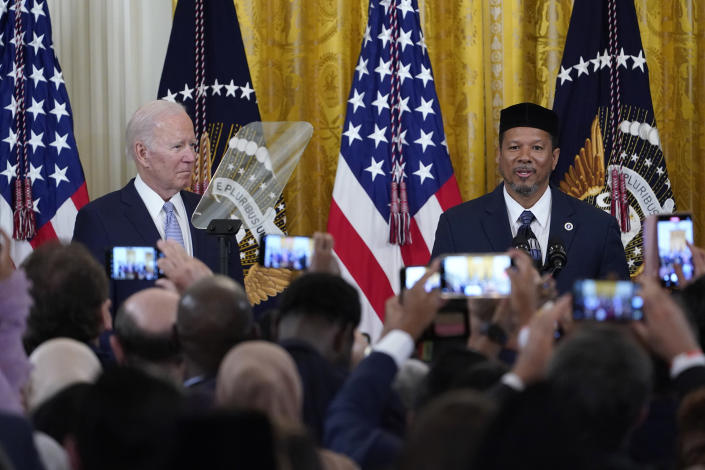 President Joe Biden, left, listens as Talib M. Shareef, right, President and Imam of the historic, Nation's Mosque, Masjid Muhammad in Washington, speaks during a reception to celebrate Eid al-Fitr in the East Room of the White House in Washington, Monday, May 2, 2022. (AP Photo/Susan Walsh)