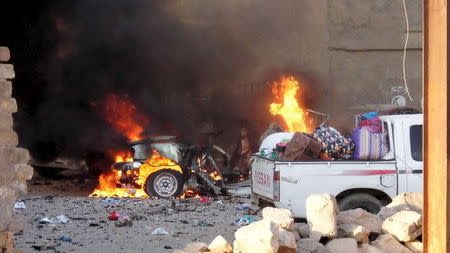 A car is engulfed by flames during clashes in the city of Ramadi, May 16, 2015. REUTERS/Stringer