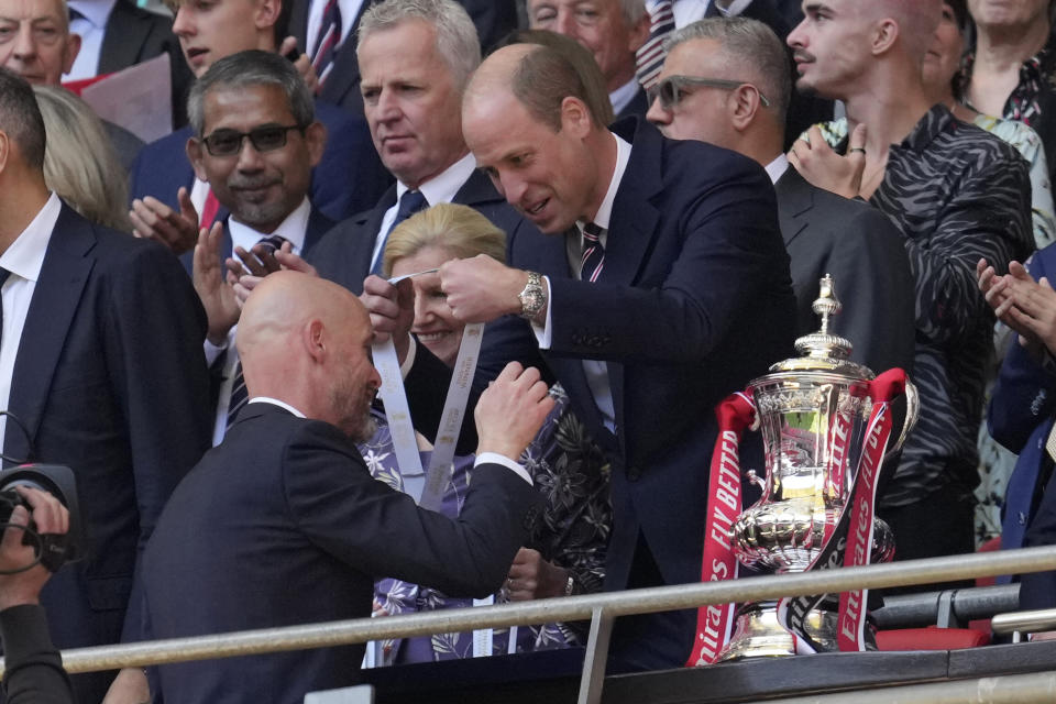 Manchester United's head coach Erik ten Hag, left, receives his winner's medal from Britain's Prince William, after his team won the English FA Cup final soccer match between Manchester City and Manchester United at Wembley Stadium in London, Saturday, May 25, 2024. Manchester United won 2-1. (AP Photo/Kin Cheung)