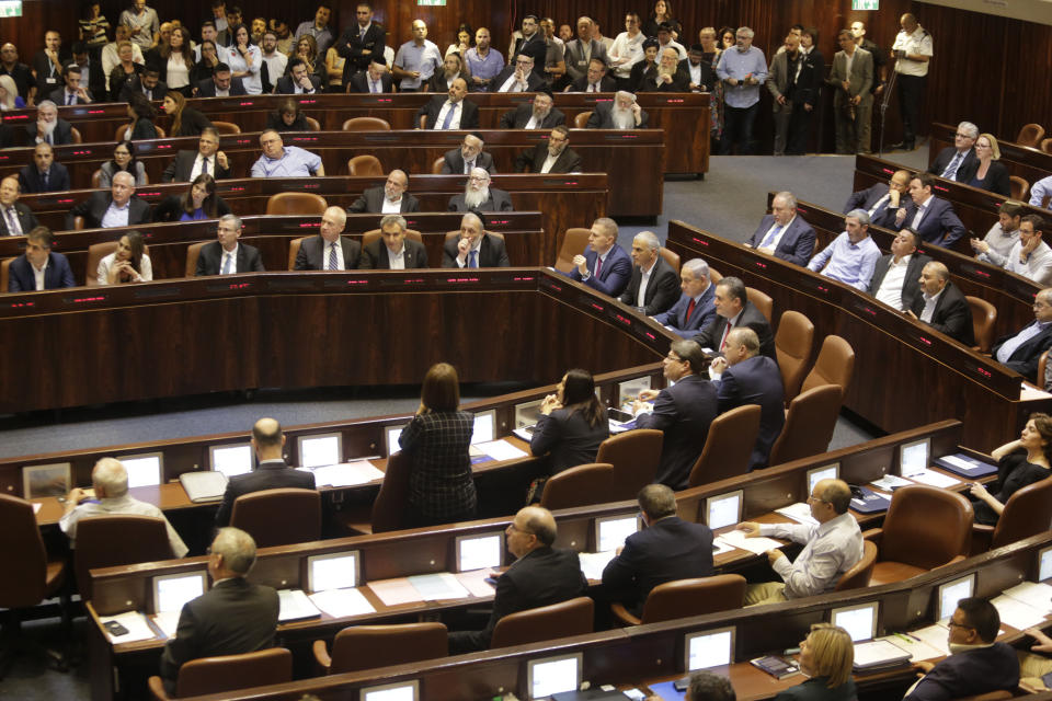 Israeli Ministers and Parliament Members in their chairs before voting in the Knesset, Israel's parliament in Jerusalem, Wednesday, May 29, 2019. Israel's parliament has voted to dissolve itself, sending the country to an unprecedented second snap election this year as Prime Minister Benjamin Netanyahu failed to form a governing coalition before a midnight deadline. (AP Photo/Sebastian Scheiner)