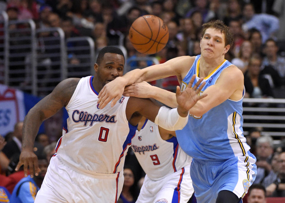 Los Angeles Clippers forward Glen Davis, left, and Denver Nuggets center Timofey Mozgov, of Russia, compete for a loose ball during the first half of an NBA basketball game, Tuesday, April 15, 2014, in Los Angeles. (AP Photo/Mark J. Terrill)