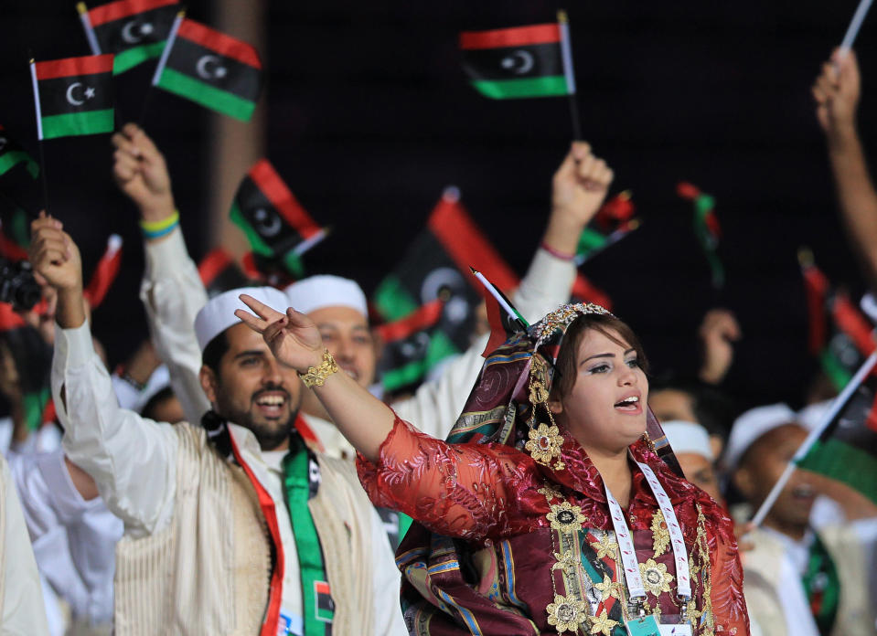 Members of the Libyan team wave national flags during the opening ceremony of the pan-Arab Games in the Qatari capital Doha on December 9, 2011. More than 5,000 Arab athletes are participating in the Arab games from December 9 to 24. AFP PHOTO/KARIM JAAFAR (Photo credit should read KARIM JAAFAR/AFP/Getty Images)