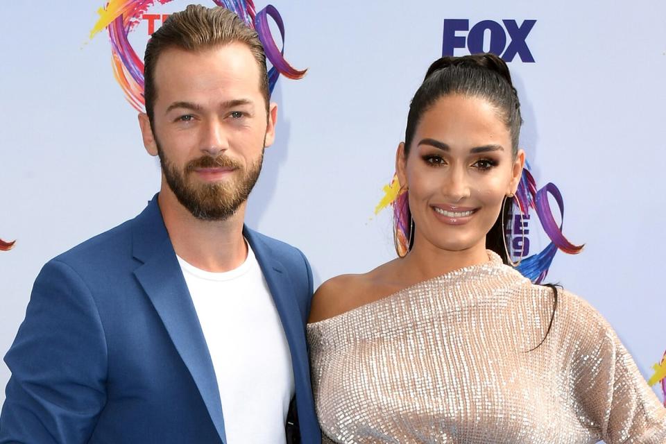 Artem Chigvintsev (L) and Nikki Bella attend FOX's Teen Choice Awards 2019 on August 11, 2019 in Hermosa Beach, California.