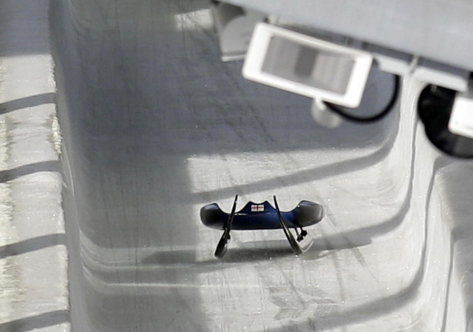 FILE - In this Friday, Feb. 12, 2010 file photo, the sled belonging to Nodar Kumaritashvili of Georgia sits empty on the track just after he crashed during a training run for the men's singles luge at the Vancouver 2010 Olympics in Whistler, British Columbia, Canada. Kumaritashvili died when he lost control of his sled at nearly 145 kph (90 mph), flew off course and slammed into a steel pole. The horrifying death of Kumaritashvili cast a pall over the Vancouver Games, raised questions about track safety and design and changed Olympic luge forever. (AP Photo/Michael Sohn, File)