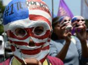 A protester wears a skull-mask during a protest against a greater US military presence in the region, near the US embassy in Manila on April 7, 2014