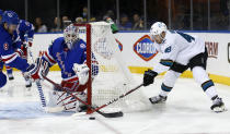 New York Rangers' Jacob Trouba (8) and goalie Igor Shesterkin (31) stop San Jose Sharks' Tomas Hertl (48) during the first period of an NHL hockey game Friday, Dec. 3, 2021, in New York. (AP Photo/John Munson)