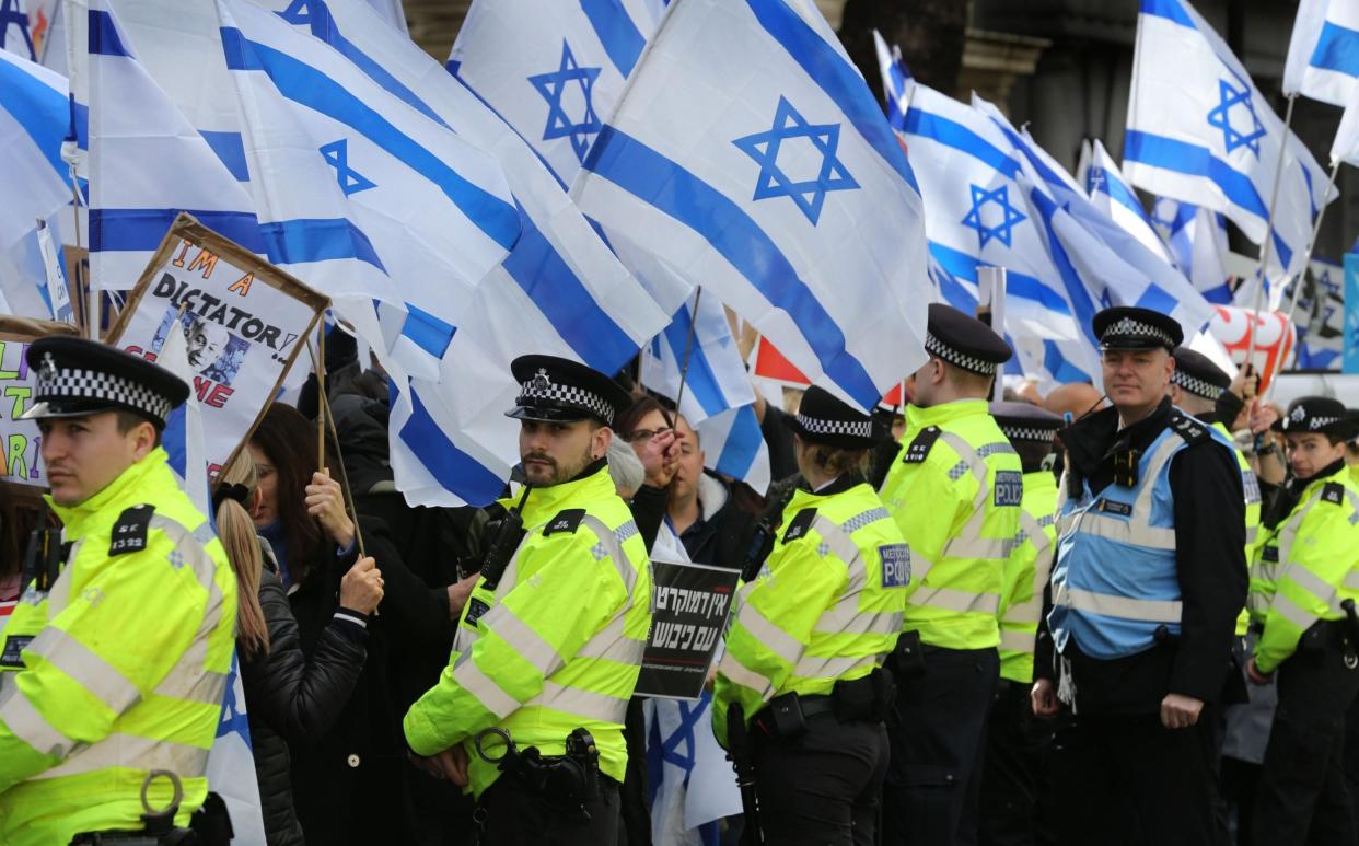 Demonstrators against Netanyahu were waving Israeli flags, not burning them - Martin Pope/Getty Images