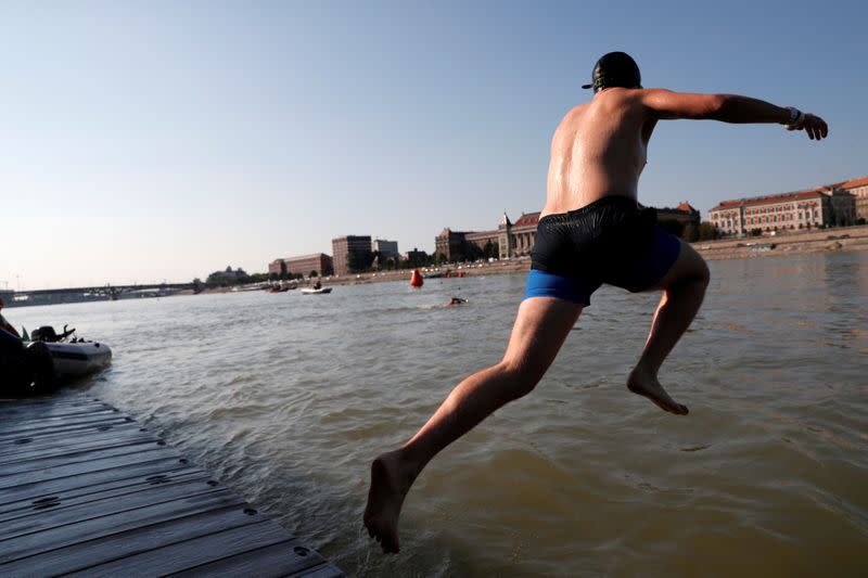 Participants swim across the Danube River during the Budapest Urban Games in Budapest