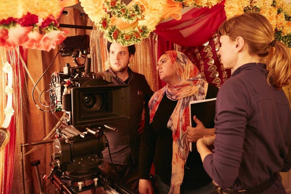 Iman Zawahry, center, watches a scene being prepared during the filming of "American-ish."