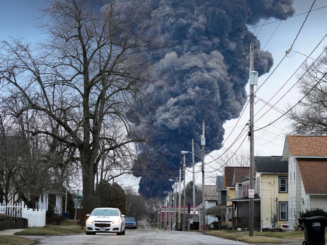 A dark plume of smoke rises from a train derailment in East Palestine, Ohio, that leaked toxic chemicals.