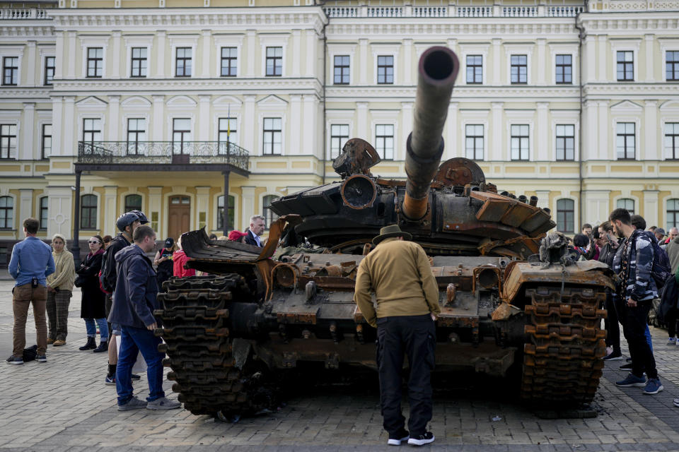 FILE - A man looks at a destroyed Russian tank placed as a symbol of war in downtown Kyiv, Ukraine, May 23, 2022. The Kremlin and Russian state media are aggressively pushing a baseless conspiracy theory blaming the United States for damage to natural gas pipelines in the Baltic Sea in what analysts said Friday, Sept. 30 is another effort to split the U.S. and its European allies.(AP Photo/Natacha Pisarenko, File)