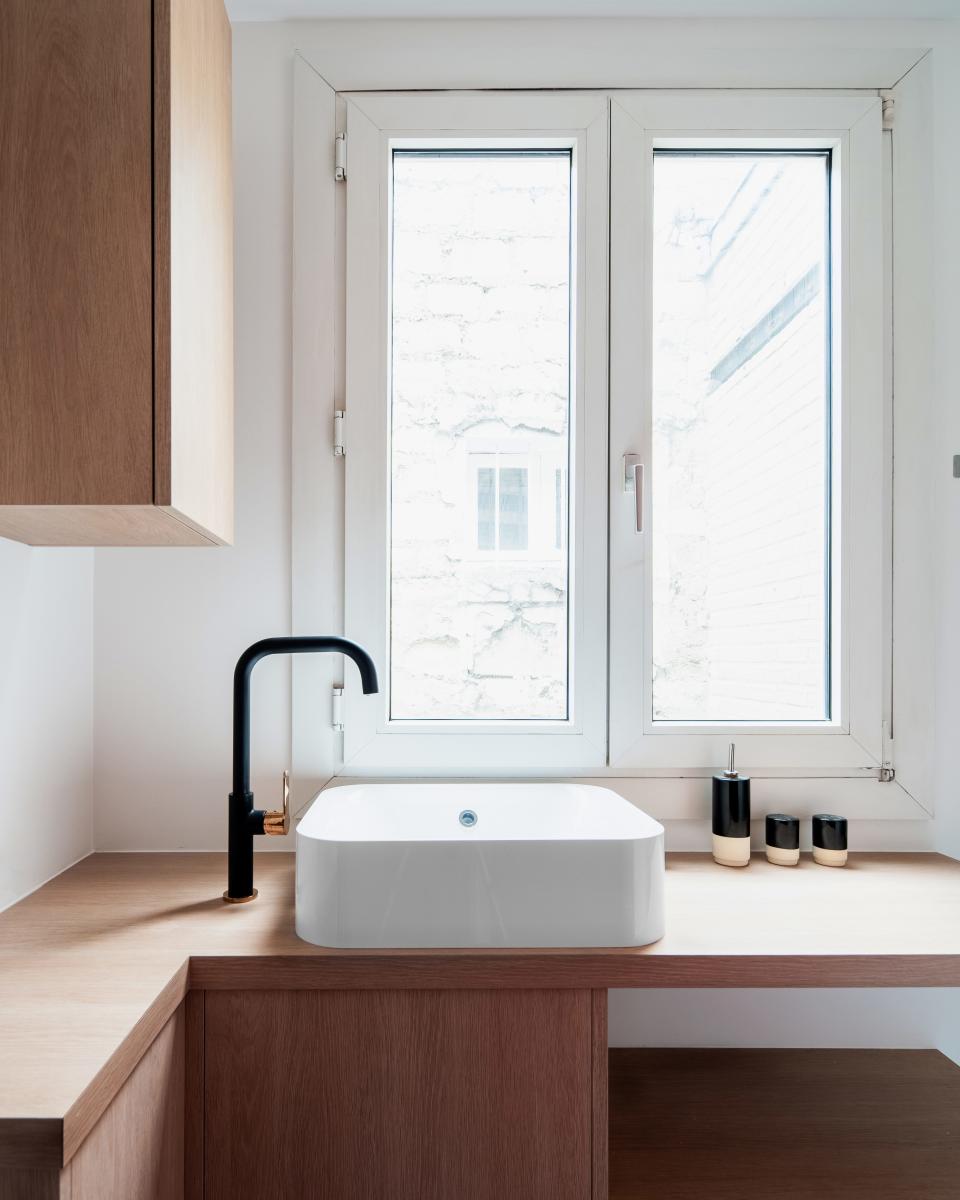 When a sink is the only appliance on display, it better look good. Same for the incredibly chic black and rose gold faucet. This streamlined black-and-white combo goes well with the tile work too.