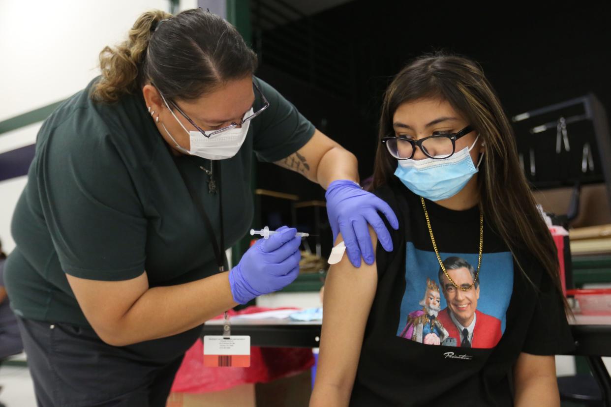 July 2021 file photo of Ylianna Ungos getting her first shot of the Pfizer vaccine at William D. Slider Middle School in the Socorro ISD.