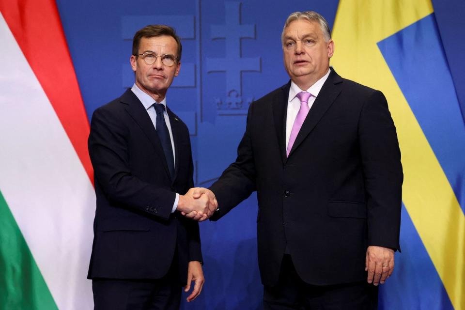 Swedish Prime Minister Ulf Kristersson and Hungarian Prime Minister Viktor Orban shake hands in Budapest on February 23 (REUTERS)