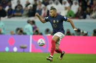 France's Kylian Mbappe runs with the ball during the World Cup quarterfinal soccer match between England and France, at the Al Bayt Stadium in Al Khor, Qatar, Saturday, Dec. 10, 2022. (AP Photo/Francisco Seco)