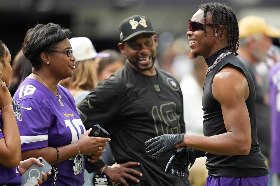 <p>Anthony Souffle/Star Tribune/Getty</p> Justin Jefferson with his mother Elaine, and father, John, ahead of an NFL Preseason game between the Minnesota Vikings and the San Francisco 49ers on August 20, 2022.