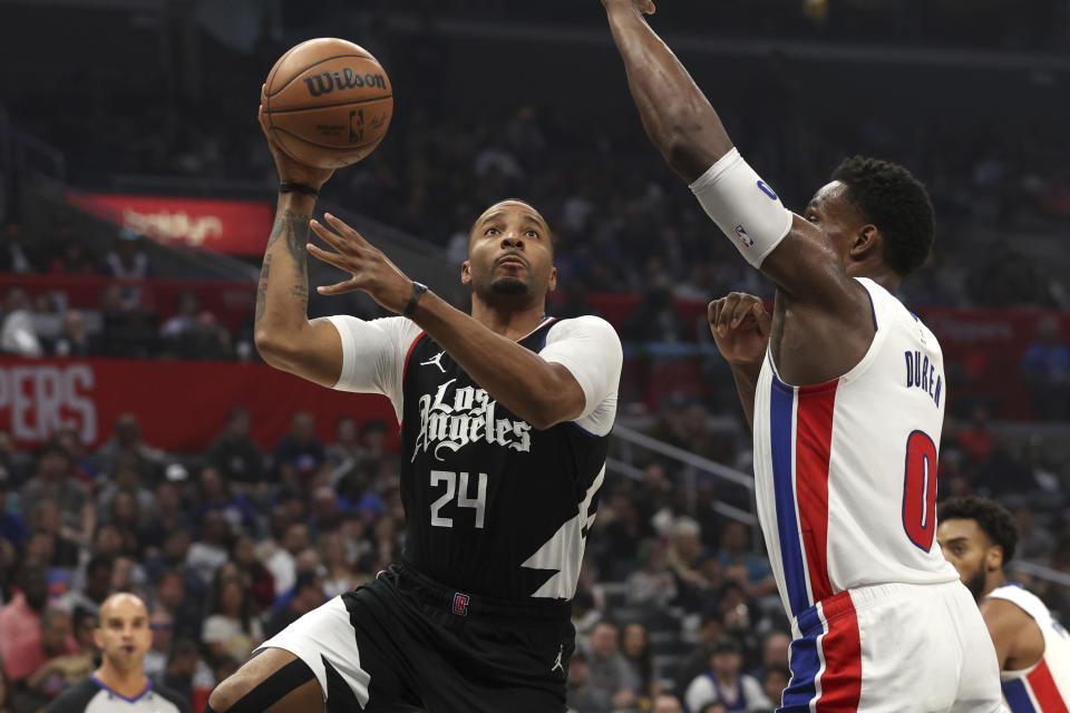 Los Angeles Clippers guard Norman Powell, left, shoots the ball defended by Detroit Pistons center Jalen Duren during the first half of an NBA basketball game, Saturday, Feb. 10, 2024, in Los Angeles. (AP Photo/Raul Romero Jr.)