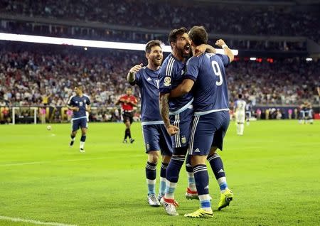 Jun 21, 2016; Houston, TX, USA; Argentina forward Gonzalo Higuain (9) celebrates with forward Ezequiel Lavezzi (middle) and midfielder Lionel Messi (10) after scoring a goal during the second half against the United States in the semifinals of the 2016 Copa America Centenario soccer tournament at NRG Stadium. Kevin Jairaj-USA TODAY Sports