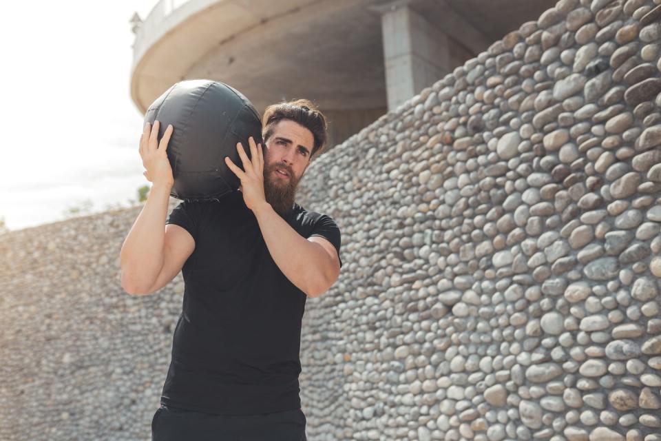 men running with the medicine ball outdoor