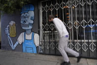 The windows of the closed Baby Blues BBQ restaurant are seen locked in Los Angeles Monday, Jan. 25, 2021. California has lifted regional stay-at-home orders statewide in response to improving coronavirus conditions. Public health officials said Monday that the state will return to a system of county-by-county restrictions intended to stem the spread of the virus. Local officials could choose to continue stricter rules. The state is also lifting a 10 p.m. to 5 a.m. curfew. (AP Photo/Damian Dovarganes)