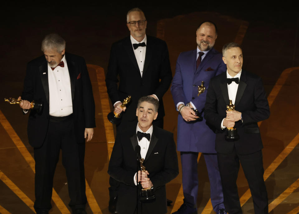 Mark Weingarten, Stuart Wilson, Al Nelson, James Mather, and Chris Burdon accept the Best Sound award for Top Gun: Maverick during the Academy Awards on March 12.