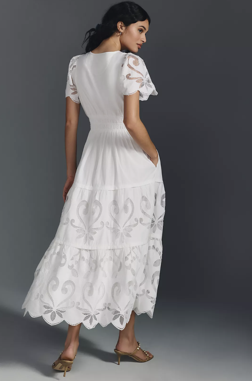 brunette model wearing heeled sandals and The Somerset Maxi Dress: Cutwork Edition in white (photo via Anthropologie)