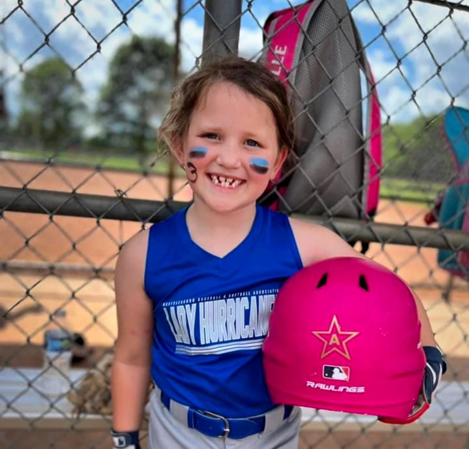 Evalyn Hayes holds her helmet that has a sticker for Asher Sullivan on it. Over 3,000 sports helmet stickers donated by Jessica Hood, the owner of JM Embroidery in Rockvale community, honor Asher Sullivan, the 10-year-old boy injured in the May 8, 2024, storm that hit Rutherford County. The sticker design is a star that's similar to Vanderbilt University's logo for one of Asher's favorite baseball teams and has the letter "A" instead of "V," Hood said. Asher is the youngest son of Rutherford County Schools Director James "Jimmy" Sullivan.