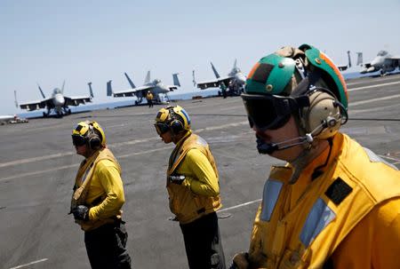 US Navy sailors stand on the flight deck of the USS Harry S. Truman aircraft carrier in the eastern Mediterranean Sea June 13, 2016. REUTERS/Baz Ratner