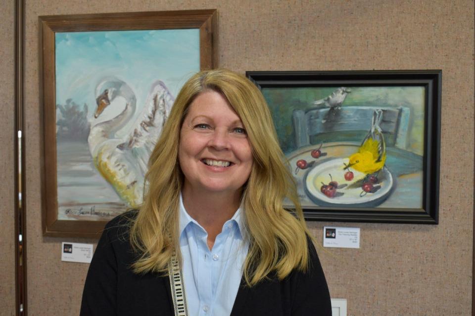 Kimberly Kaufmann, executive director of Black Swamp Bird Observatory, said there is a vital connection between bird tourism and bird conservation. Here, she attends the Feather to Frame art exhibit at The Arts Garage in Port Clinton on Sunday. The art exhibit, which runs through May 22, is one of many events available to the thousands of birders who will visit Ottawa County during the Biggest Week in American Birding.