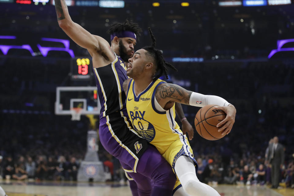 Golden State Warriors' D'Angelo Russell (0) is defended by Los Angeles Lakers' JaVale McGee during the first half of an NBA basketball game Wednesday, Nov. 13, 2019, in Los Angeles. (AP Photo/Marcio Jose Sanchez)