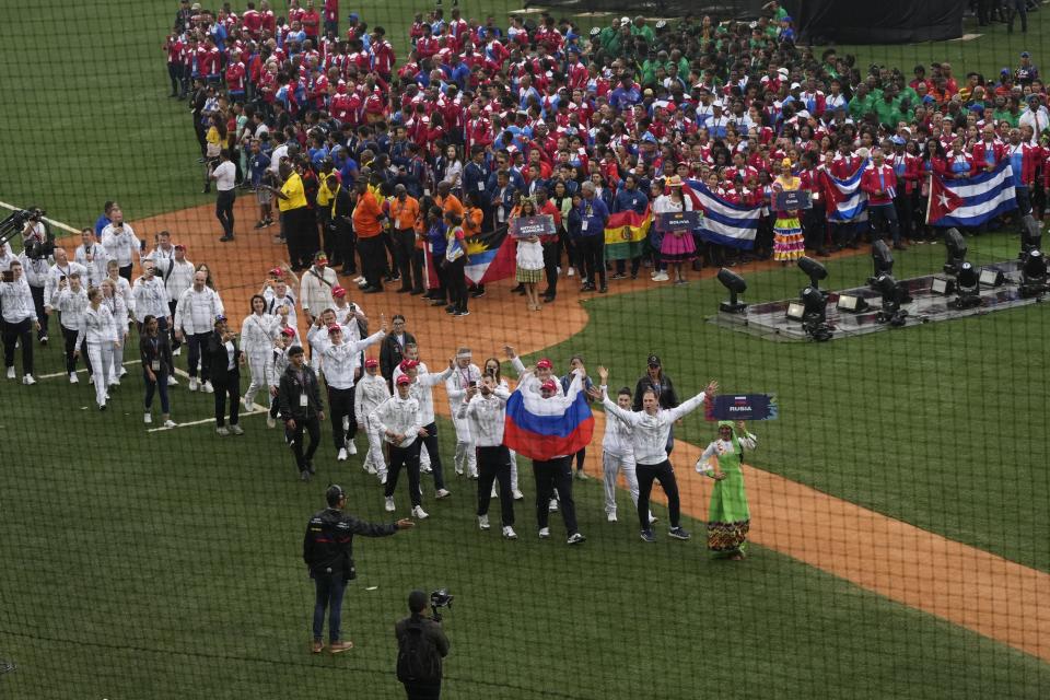 Russian athletes parade in the Alba Games' opening ceremony at the baseball stadium in La Guaira, Venezuela, Friday, April 21, 2023. (AP Photo/Ariana Cubillos)